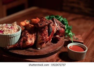 Rotisserie Chicken dinner, breast and wing side, with coleslaw and hot sauce