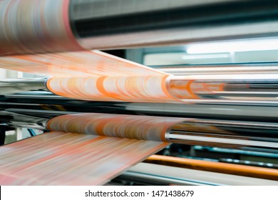 Rotogravure Printing method. It is one of flexible packaging process. Plan film was printed each color thru cylinder. Machine is running in high speed mode. This system is suitable for repeated work. - Shutterstock ID 1471438679