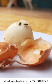 Rotten Egg In White Plate On Wood Background.