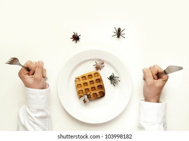 Rotten Food Concept. Man Holding Fork And Knife Insects And Bugs Eat The Waffle Isolated On White From Top View.