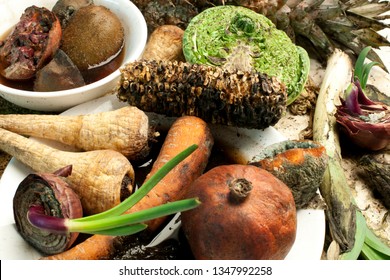 Rotten fruit and vegetables on a pile.