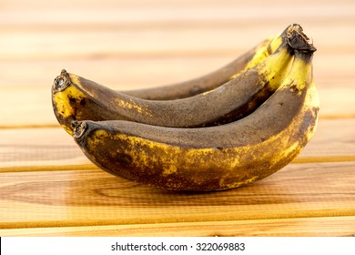 Rotten Old Bananas On Wooden Background