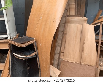 Rotten wooden furniture in a pile of garbage - Powered by Shutterstock