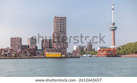 Rotterdam cityscape timelapse with Euromast observation tower and a tourist boat on Nieuwe Maas River. Waterfront features modern skyscrapers, a floating Chinese restaurant and a scenic harbor view