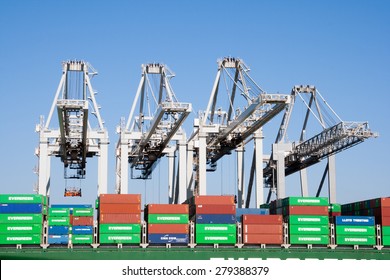 ROTTERDAM - MAR 8, 2011: Container cranes loading a ship in the port of Rotterdam. This port is the Europe's largest and facilitate the needs of a hinterland with 40,000,000 consumers.
