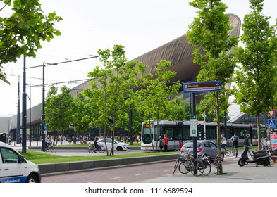 Rotterdam, Netherlands, 15-6-2018: A busy street nearby Rotterdam central station with a tram passing by