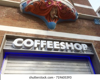 Rotterdam, The Netherlands 21-09-2017: A Coffeeshop Sign With Above It A Artwork Of A Lady With Red Hair Smoking A Joint