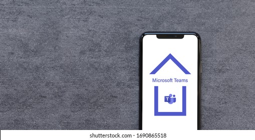 Rotterdam, The Netherlands - April 2020: Smartphone with Microsoft Teams App Logo inside House video conferencing service Work at Home Quarantine or Lockdown Concept.