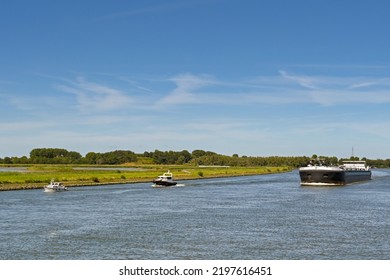 Rotterdam, Netherlands - August 2022: Industrial Barge Sailing With Two Small Lesiure Boats. Contrast Concept