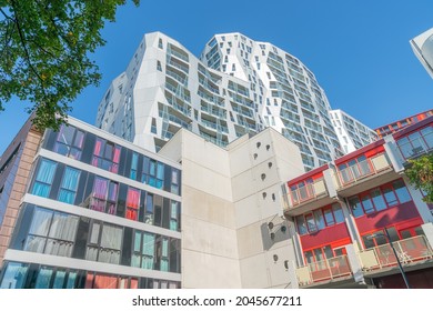 Rotterdam Netherlands - August 23 2017; Towering white and red creative design of De Calypso apartment building rising from street below