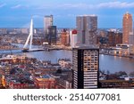 Rotterdam, Netherlands city skyline over the Nieuwe Maas River at twilight.