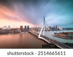 Rotterdam, Netherlands city skyline over the river at twilight.