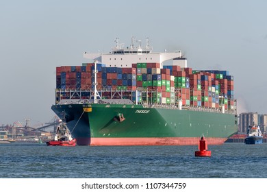 ROTTERDAM, THE NETHERLANDS - FEBRUARY 16, 2018: The Large Container Ship Theseus Is Escorted By Tugs At Its Arrival At The Maasvlakte, Port Of Rotterdam On February 16, 2018.