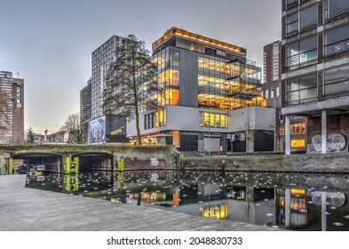 Rotterdam, The Netherlands, January 1, 2016: The Renovated Huf Building From The Post-war Reconstruction Era, Reflecting In The Adjacent Canal In The Blue Hour