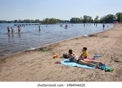 Rotterdam, Netherlands – June 2, 2021: People having fun on the beach and in water of the Kralingse Plas in Rotterdam