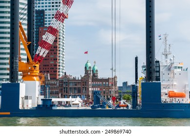 Rotterdam, Netherlands - June 21st, 2014: Rotterdam Harbor Overlooking The Hotel New York And A Construction Vessel For The Construction Of Offshore Wind Farms