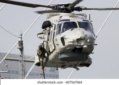 ROTTERDAM, NETHERLANDS - SEP 3, 2016: Anti-piracy demonstration with Dutch marines entering a vessel from a NH90 helicopter during the World Harbor Days in Rotterdam.