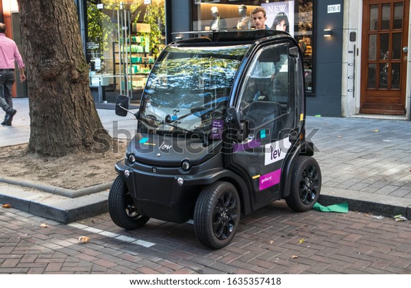 Rotterdam / Netherlands - September\
15, 2019 : Modern electric car parked on the street.  Tiny\
car