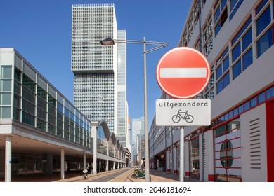 Rotterdam, Netherlands – September 22, 2021:  One way street except for bikes on the famous Wilhelminakade in Rotterdam with the photo museum on the right and Rem Koolhaas Building in the background