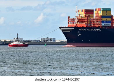 Rotterdam, The Netherlands-Sept 2019: View Of A Section Of The Bow Of MSC Gulsun Containership With Red Tug Boat In Front; Maiden Call In Rotterdam