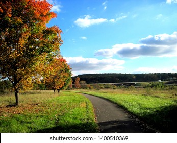 Rotterdam, New York 10/2/2014: Fall Foliage View Along The Erie Canal Bike Path With The New York State Thruway Toll Road In The Background.