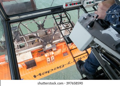 ROTTERDAM - SEP 9, 2015: Gantry Crane Operator Moving A Sea Container In The Port Of Rotterdam.