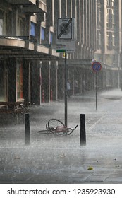 Rotterdam,Netherlands-07 26 2018:Forgotten Bicycle Under Heavy Rain Storm In Rotterdam.