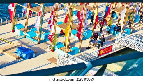 ROUEN, FRANCE - JUNE 8, 2019. Colorful Wooden Terrace With Table, Chairs And Flags, Ready For A Street Cafe Or Restaurant, During The Aramda Time, International Meeting For Sailboats. Aerial View