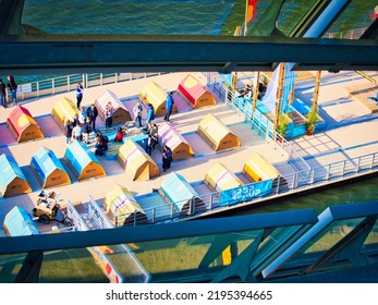 ROUEN, FRANCE - JUNE 8, 2019. Colorful Wooden Terrace With Table, Chairs And Flags, Ready For A Street Cafe Or Restaurant, During The Aramda Time, International Meeting For Sailboats. Aerial View 