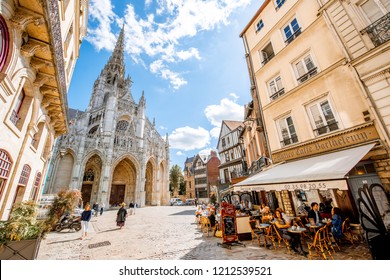 ROUEN, FRANCE - September 07, 2017: Street view with saint Maclou gothic cathedral during the sunny day in Rouen