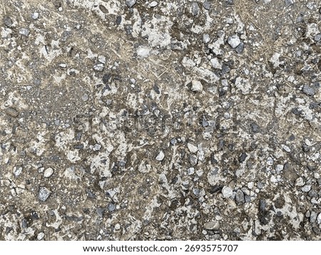 Rough asphalt surface texture with small stones, showing detailed pattern of a natural and strong road.