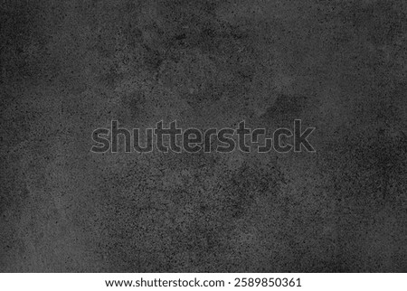 A rough black surface presents an intriguing pattern and texture, hinting at layers.