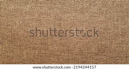 Rough burlap texture, canvas coarse cloth, dark brown woven rustic bagging. Natural hessian jute, beige textile texture. Linen fabric pattern. Threads background. Sackcloth surface, sacking material.