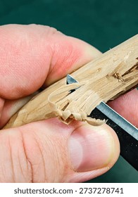 Rough carving with a chisel on a dry apple branch