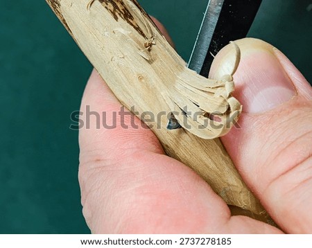 Rough carving with a chisel on a dry apple branch