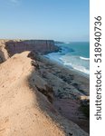 Rough coast line with towering cliffs and wild ocean in Angola