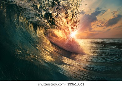 rough colorful ocean breaking surf wave falling down at sunset time