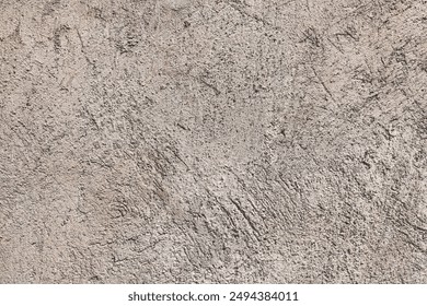 Rough concrete beige wall with chaotic relief on it. Grunge texture, minimal background. Cement surface close-up. Easily add organic depth to your designs. - Powered by Shutterstock