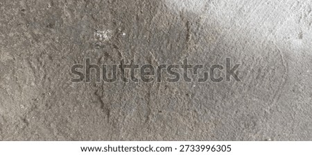 Rough Concrete Floor Texture with Subtle Dirt and Grain. Close-up of concrete floor showing fine grain and dirt texture, suitable for neutral abstract backgrounds