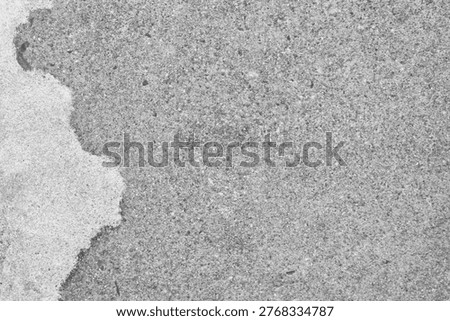 Rough concrete texture background in grayscale, featuring a mix of smooth and grainy surfaces.