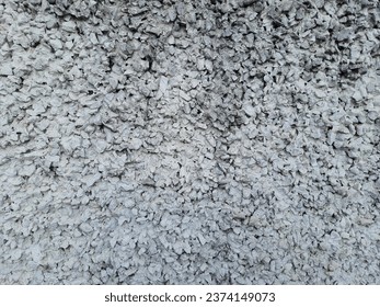 Rough concrete wall made of exposed aggregate pebbles and cement.Front view, full screen. Backgrounds and textures. - Shutterstock ID 2374149073