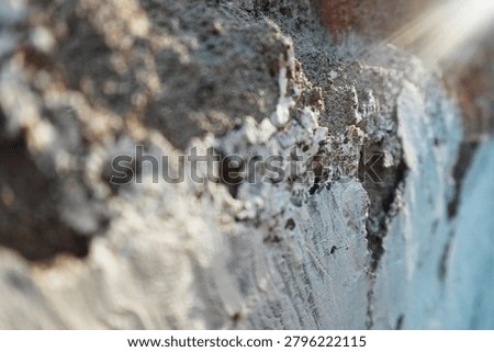 A rough concrete wall surface with sun flare