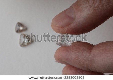 Rough diamond in evaluating process at diamond expert workplace.