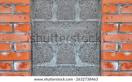 Rough Gray Cinder Blocks And Orange Textured Bricks Wall Front View Closeup Patterned Symmetry Vertical Composition Contrast Colorful