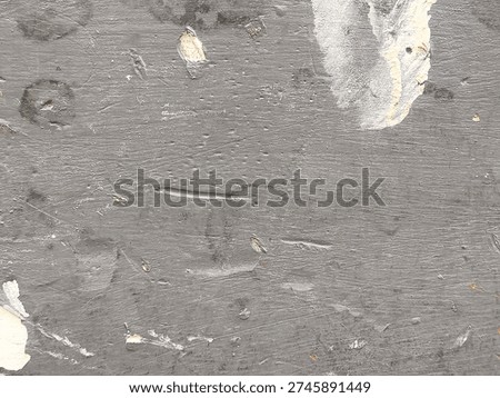 Rough gray plaster surface with white repair patch and scattered grit, handmade trowel marks and microcracks, authentic building material background for maintenance, DIY, and inspection use