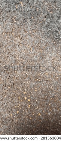 Rough, grayish-black surface of old andesite stone