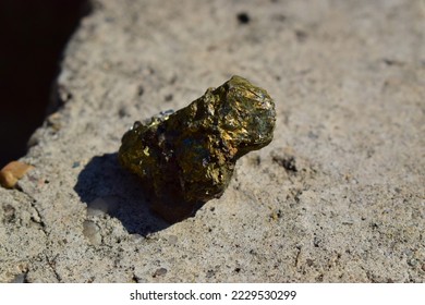 Rough mineral chalcopyrite on stone background, a closeup of mineral stone, macro shot of shinny yellow brown stone on day light, geology. - Shutterstock ID 2229530299