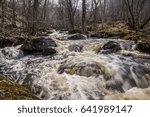 A rough mountain stream flows between the rocks