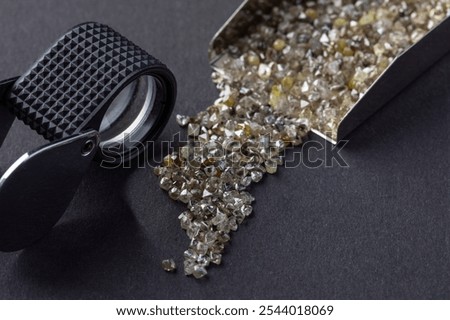 Rough natural diamonds in the process of sorting by quality and color. Close up scattering uncut diamonds top view.