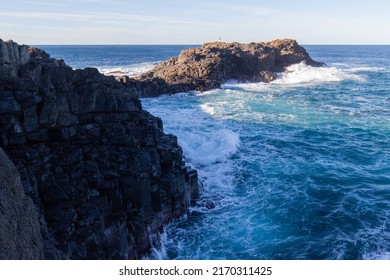 Rough Ocean Water Around The Rocky Formation.